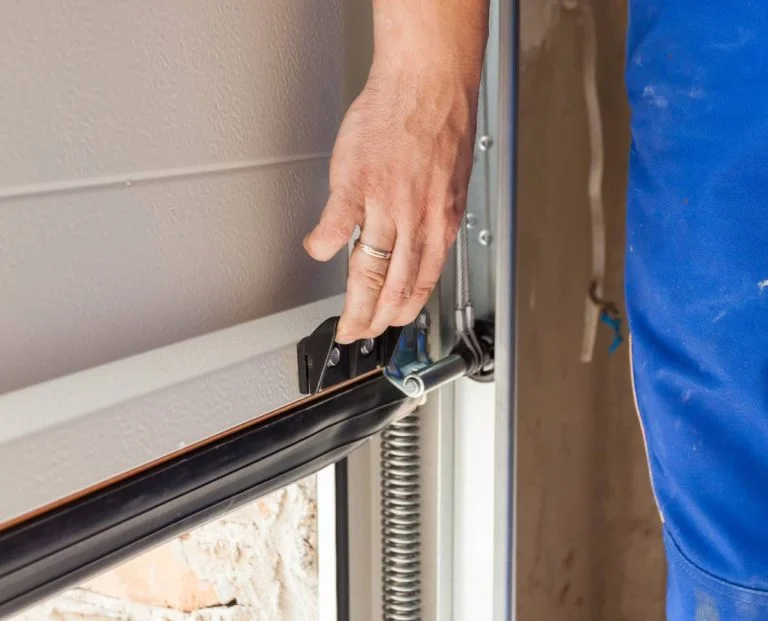 Man Operating Roller Garage Door